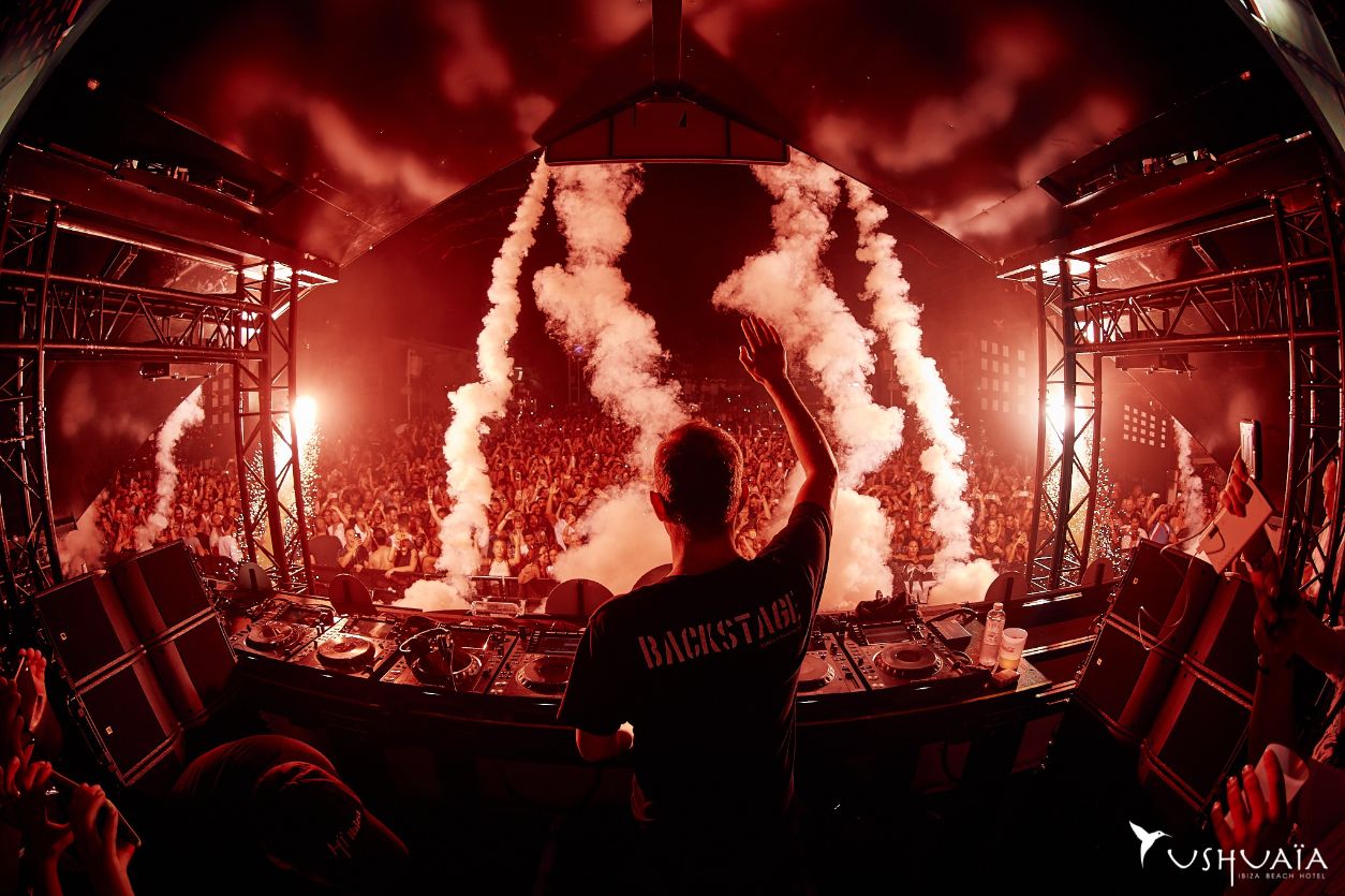 DJ hands up from stage at Ushuaia